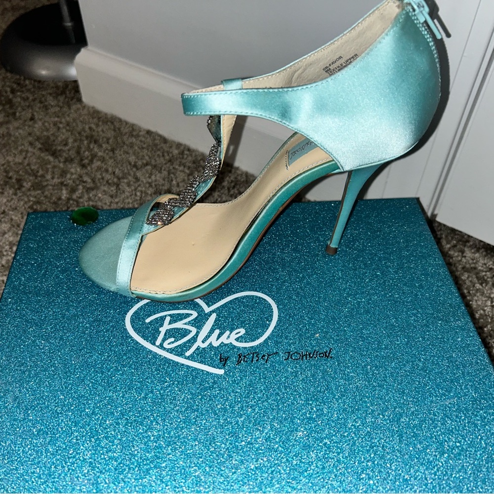 Turquoise stilettos with a silver heart shaped t-strap. Size 9 new